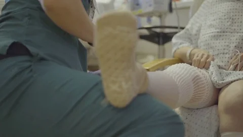 Therapist checks knee range of motion Stock Footage 73438693