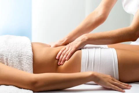 Therapist doing curative belly massage on female patient. Stock Photos