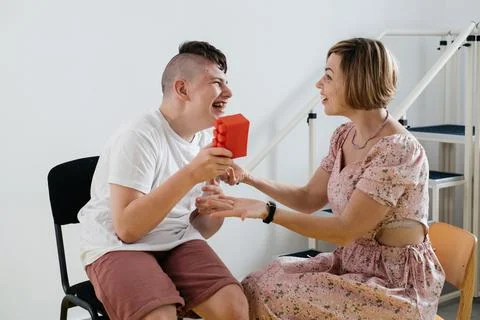Therapist doing development activities with cerebral palsy boy Stock Photos