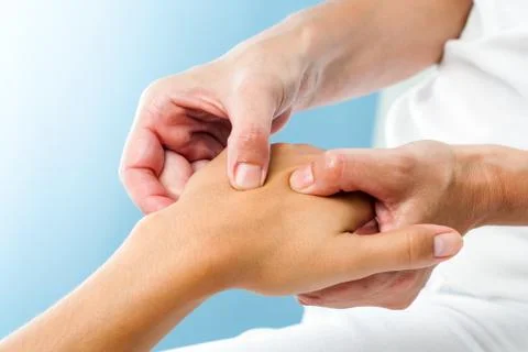 Therapist doing massage on female hand. Stock Photos