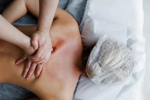 Therapist performing deep tissue back massage on woman Stock Photos
