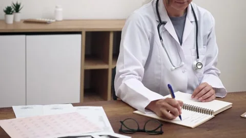Therapist studies patient documents with results of research and examinations Stock Footage 250670094