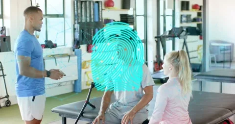 Therapist tapping tablet demonstrating biometric scan fingerprint as patient Stock Footage 316606414