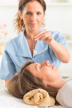 Therapist using pendulum Stock Photos