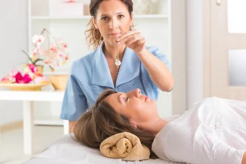 Therapist using pendulum Stock Photos