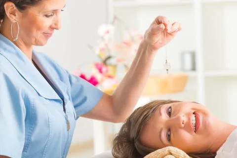 Therapist using pendulum Stock Photos