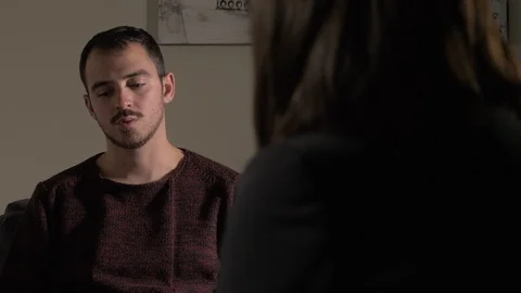 Therapy session.Sad depressed man talking with psychologist Stock Footage 105011993