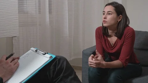 Therapy session.worried sad young woman talking with psychologist. Stock Footage 110909022