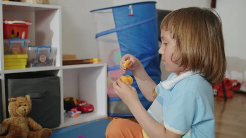 Therapy through play: joyful child, professional in white, tackling language Stock Footage 272948587