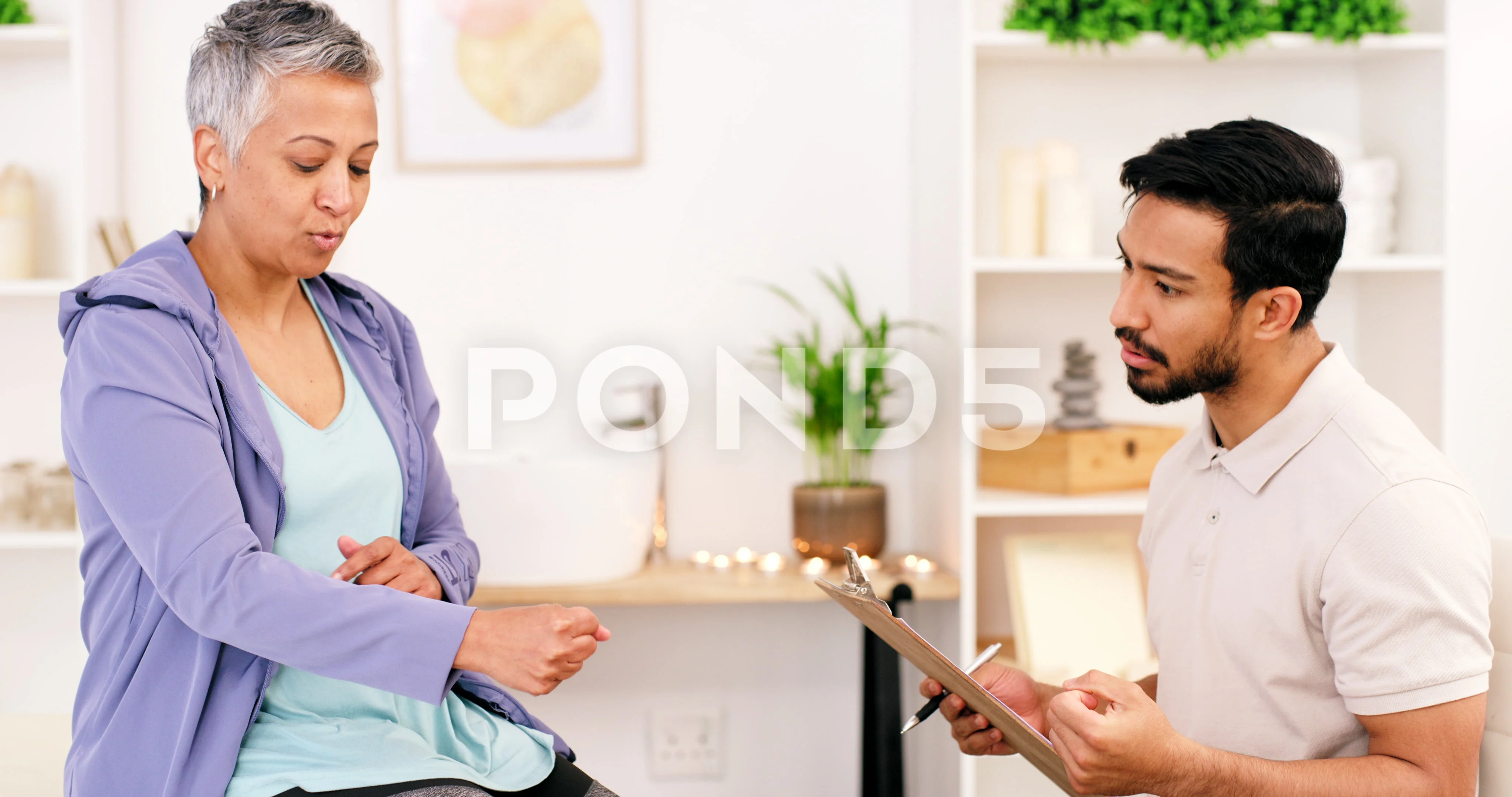 Female Doctor with Senior at Electrotherapy for Pain Relief Stock