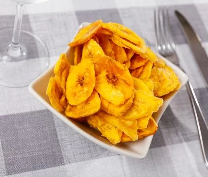 There is appetizer for low alcohol beverage - fried plantains chips Stock Photos