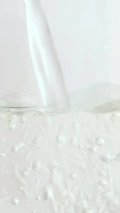 There are air bubbles in the water and a drop of water on the walls of the glass Stock Footage 277114615