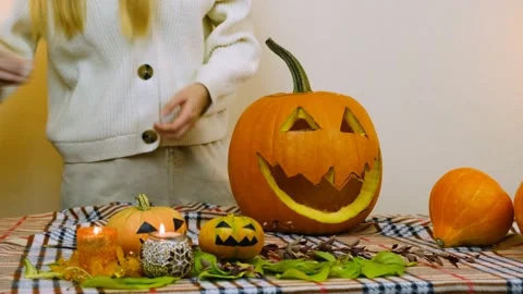 There are candles and small pumpkins on the table. Stock Footage 219259997
