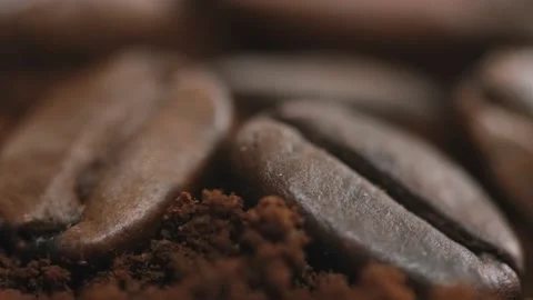 There are coffee beans on top of a freshly ground coffee bean. Many roasted Vídeo Stock 151585290