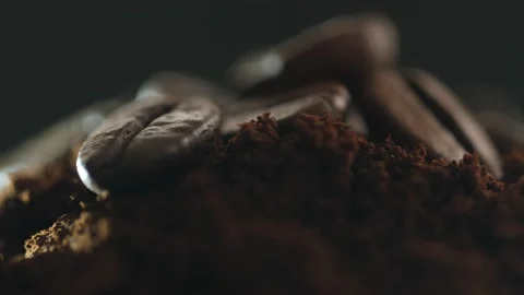 There are coffee beans on top of a freshly ground coffee bean. Many roasted Stock Footage 151659862