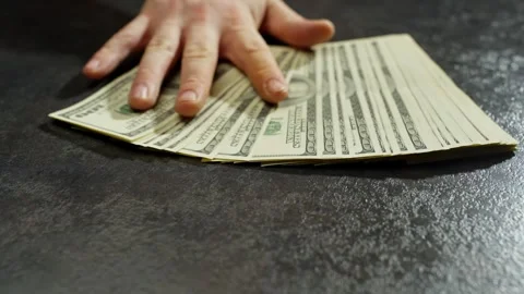 There are currency notes on the table, indicating financial relations. Stock Footage 267032618