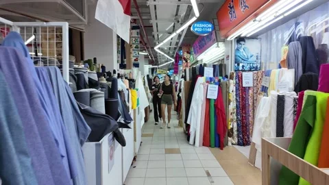 There are  different colors of fabric on display at People's Park Centre Stock Footage 318099400