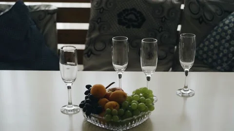 There are empty glasses and fruit on the table Stock Footage 159405747