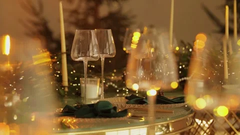 There are empty wine glasses on the table, and the table is decorated with garla Stock Footage 324850666