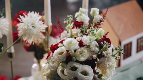 There are flowers and burning candles on the table that decorate the table Stock Footage 334388775