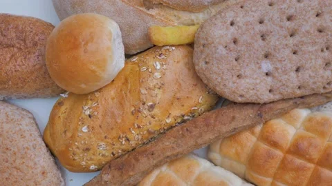 There are many different pieces of bread on the table. Tslose-up, top blows Stock Footage 227196722