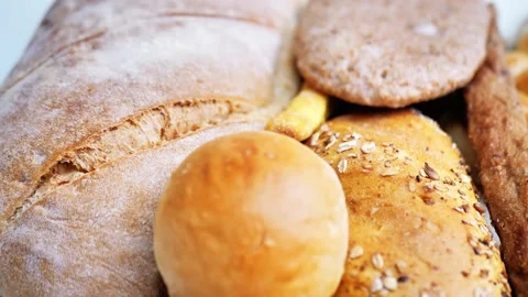 There are many different types of bread on the table. Close-up, top view. Food Stock Footage 226630382
