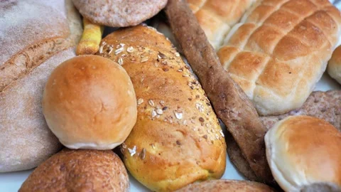 There are many different types of bread on the table. Close-up, top view. Food Stock Footage 229542971