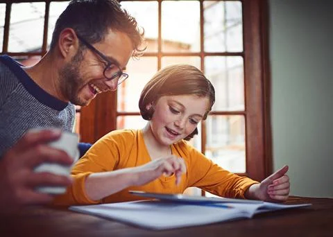 There are many helpful technological tools for daily use. a father helping his Stock Photos