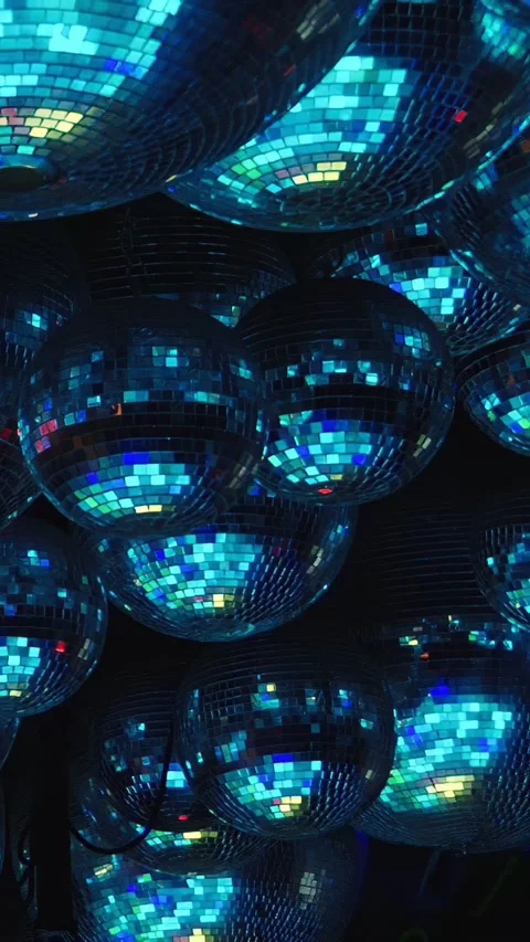 There are numerous green disco balls suspended overhead in the room Stock-Footage 275810053