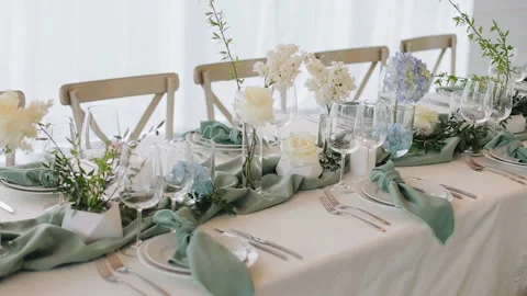 There are plates, cups, spoons and other cutlery on the festive table Stock Footage 224537694