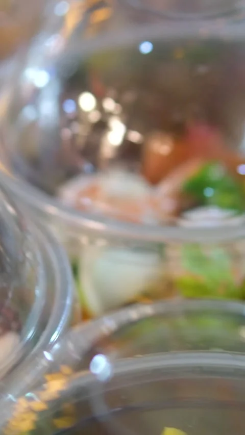There are several disposable salad plates on the table in the restaurant kitchen Stock Footage 313685539