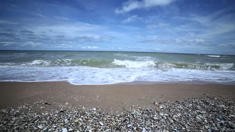 There are small pebbles and coarse sand on the coastline . Stock Footage 237958045