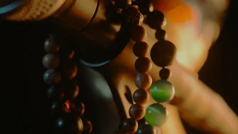 There are some bracelets hanging on a dynamic microphone in a half-light. Stock Footage 116846502