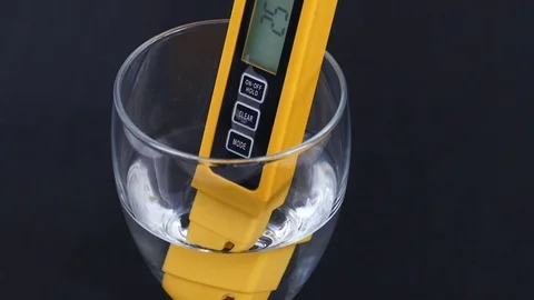 There are tds meter in the glass cup, the water hardness is measured, Stock Footage 104569878