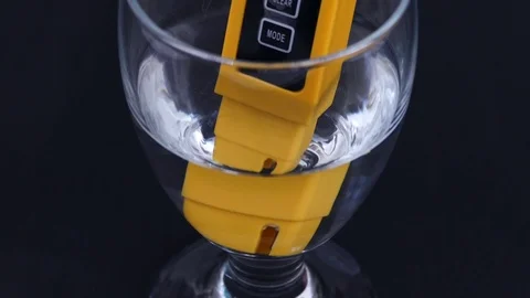 There are tds meter in the glass cup, the water hardness is measured, Stock Footage 104569899