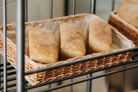 There are three bread in the bread basket. Stock Photos