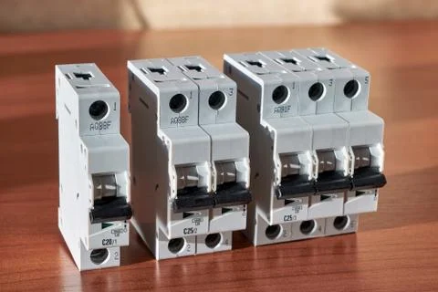 There are three electric automatic modular switches on the table. Stock Photos