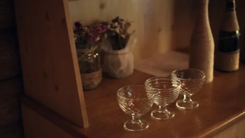 There are three empty glass glasses on the bar or kitchen table. Stock Footage 167476681