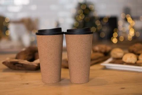 There are two cups on the table. Christmas bokeh in the background. Christmas Stock Photos