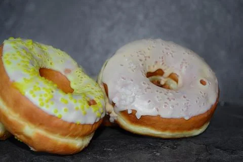 There are two donuts on the black table Stock Photos
