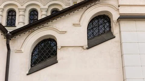There are two elegantly arched windows situated on the side of a building Stock Photos