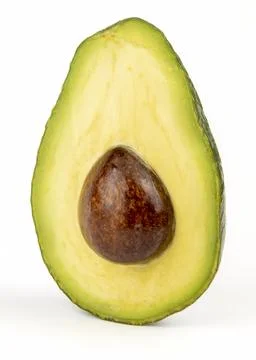 There is an avocado cut in half on the table Stock Photos