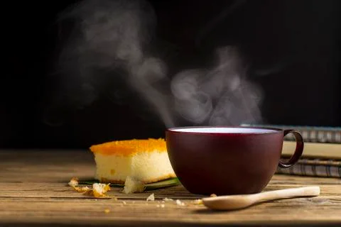 There is a book of bread and a cup of coffee with hot smoke, with the aroma o Stock Photos