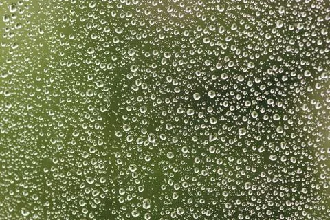 There is a closeup view on the raindrops on the window. Stock Photos