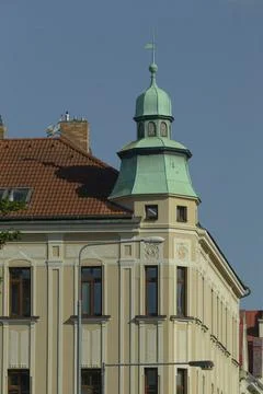 There is a distinct building featuring a green tower on its top Fotos de archivo