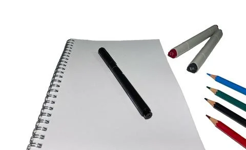 There is a drawing book on the white table and everything for this. Stock Photos