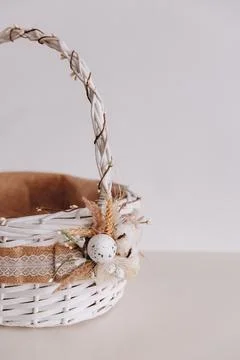 There is a Eastern basket on the white table. Stock Photos