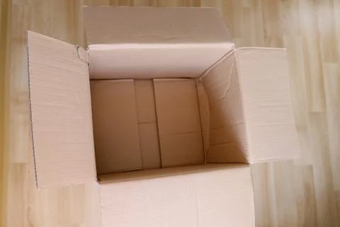 There is an empty open cardboard box on the floor, concept of mailing, packag 写真素材