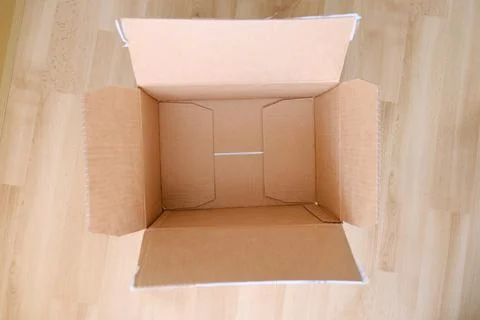 There is an empty open cardboard box on the floor, concept of mailing, packag Foto stock