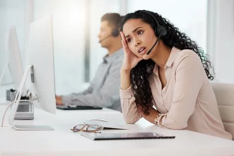 Is there even a way to solve this. a young call centre agent looking stressed Stock Photos